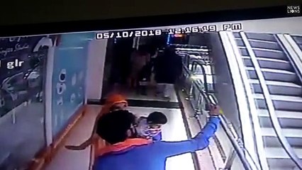 Baby slips on escalator while taking selfie