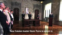 New Catalan leader is sworn in, shuns constitution