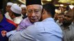 Hugs all around as Najib attends Friday prayers at Umno HQ