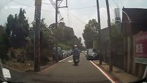 Passing moped rider hurls chunk of metal at car windscreen in Taiwan