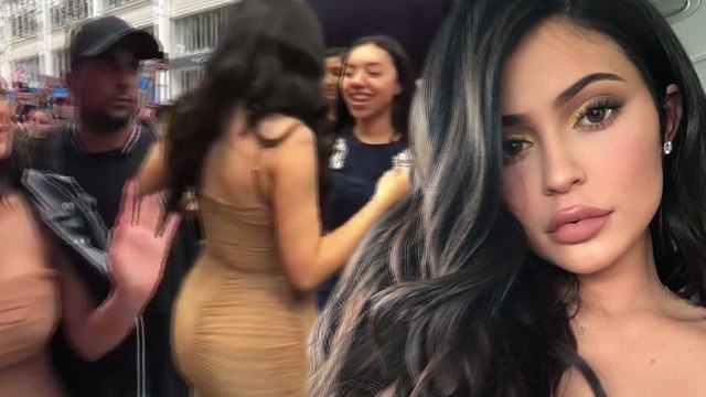Kylie Jenner flashes the flesh in low cut cream dress as she greets fans at pop up make-up store