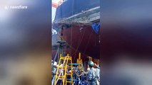 Workers filmed clinging on for life after cargo ship scaffolding collapses