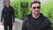 Black to basics! Hugh Jackman cuts a casual figure in a sweater and aviators as he steps out in New York City