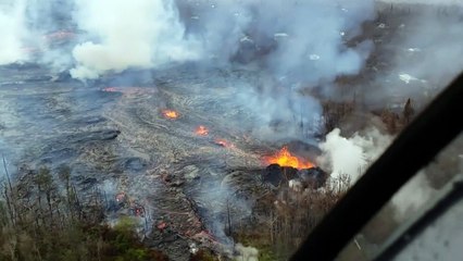 Aerial images of lava surrounding homes in Hawaii