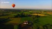 Drone camera captures hot air balloons at sunset