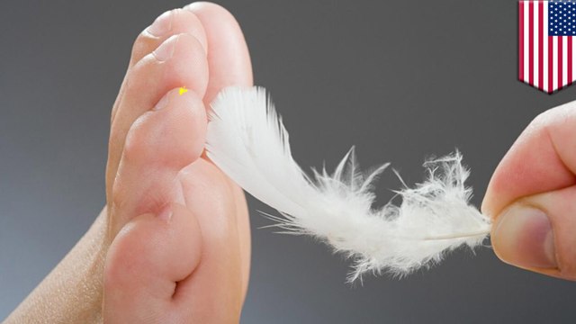 Woman laughs when she sees other people being tickled