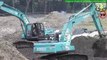 Kobelco SK200 Excavators Stockpiling Sand On River Dam Construction