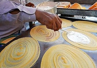 Street Food Vendor Prepares Giant Coconut Crepes in Cambodia
