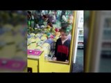 Little Henry stuck inside arcade claw machine - climbed in after failing to grab Minion