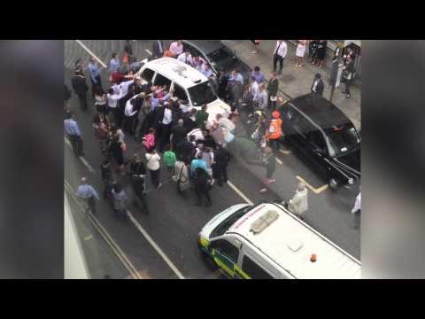 London bystanders lift taxi to save woman trapped under wheels