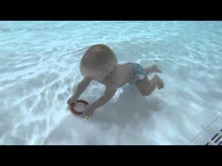 Little Olly Wilkes has learnt to swim before he could walk