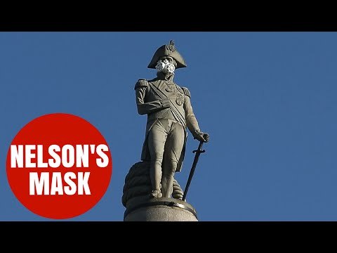 Greenpeace activists put mask on Nelson atop his column in Trafalgar square protest