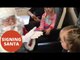 Girl With Hearing Impairment Speaking To Santa Through Sign Language