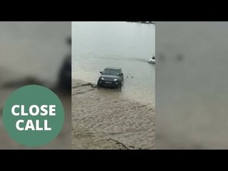 Range rover is nearly washed out to sea after trying to launch rib into water