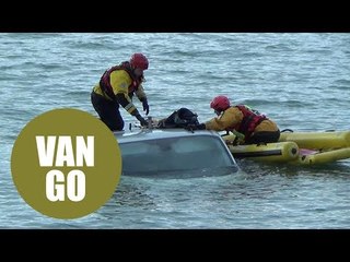 A van is completely submerged by the tide after parked on beach
