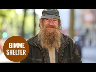 A homeless man sleeps rough opposite Shelter charity