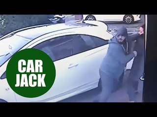 Two thugs push and grab a woman on her drive way in an attempt to car jack
