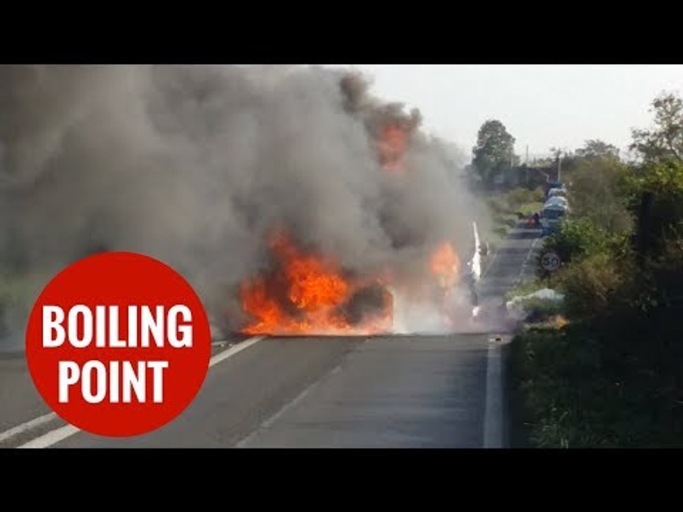 Cop car collides with BMW and dramatically bursts into flames