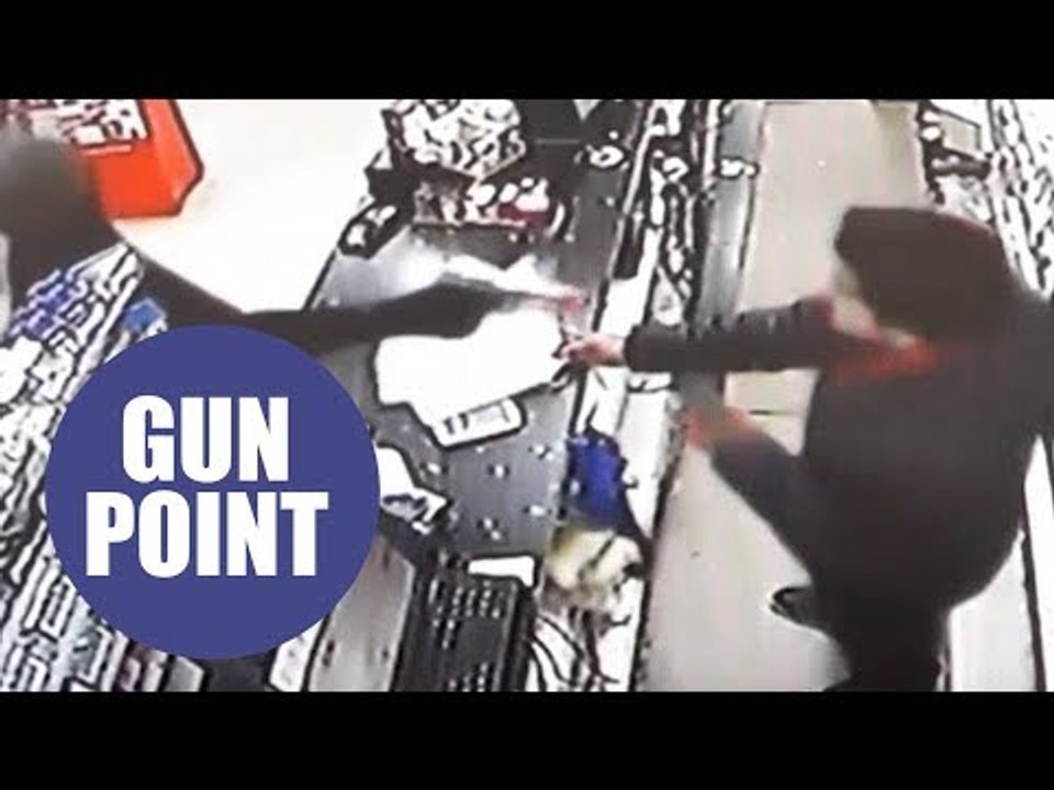 Dramatic CCTV shows have-a-go-hero shopkeeper disarming gunman during terrifying robbery