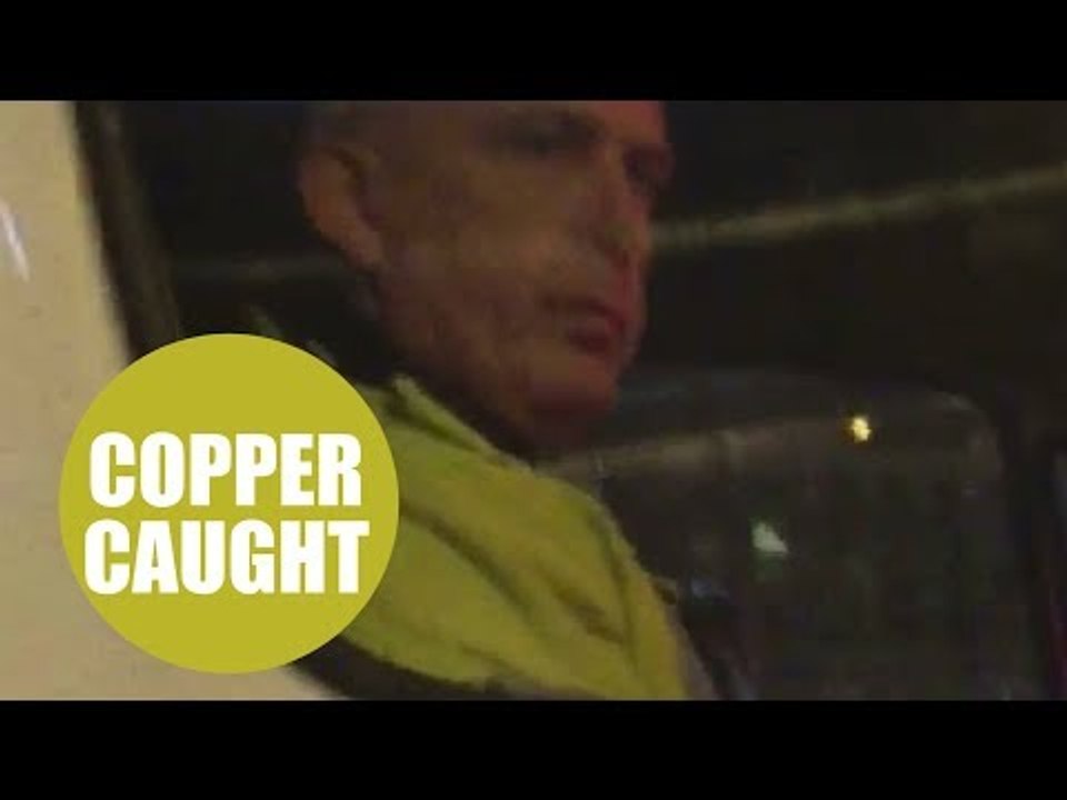 A police officer was caught on camera using his mobile phone