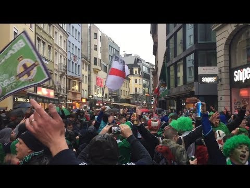 Switzerland v Northern Ireland - Northern Ireland Fans Cheer In The Pouring Rain