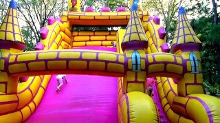 Kids playing in Amusement park Playground with Giant pink Inflatable slides - children fun videos