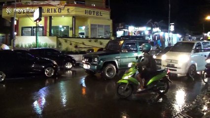 Chaos on Indonesian street as heavy rain causes power cable to collapse