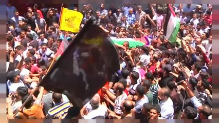 Thousands of people attend the funeral of a Palestinian nurse