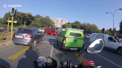 Moment motorcyclist sideswiped by car after breezing through junction