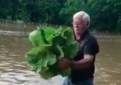 Man Drags Up Cabbage from Under Flooded Farm Fields in Georgia