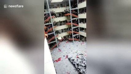 Hundreds of high school students shred books to confetti