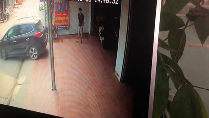 Moment woman backs straight into man guiding her into parking space