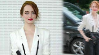 Emma Stone looks chic in plunging ivory blazer and high-waisted trousers at fashion awards in Paris