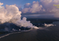 Smoke and Steam Towers Over Hawaiian Shore as Lava Streams Flow to the Ocean