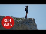 Idiots dangle over the edge of a crumbling cliff - to take SELFIES