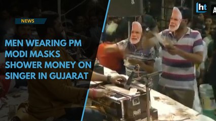 Watch: Men wearing PM Modi masks shower money on singer in Gujarat