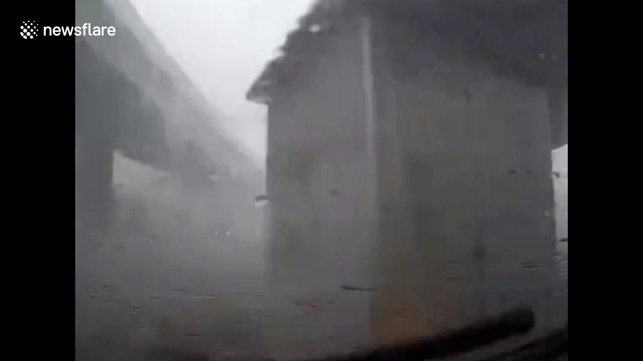 Portacabin blown across road in strong China winds