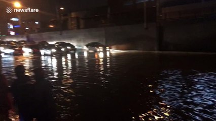 Cars stranded in flood water after tropical storm hits the Philippines