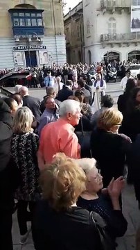 The funeral of murdered journalist Daphne Caruana Galizia has just taken place and mourners are leaving Mosta church.