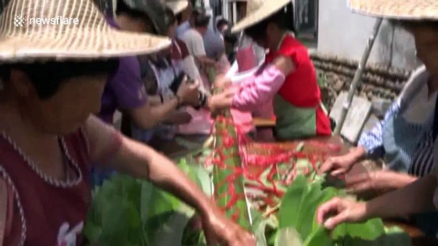 Villagers make 20-metre-long rice dumpling for Dragon Boat Festival
