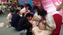 In China, pregnant women get their baby bumps painted for fun