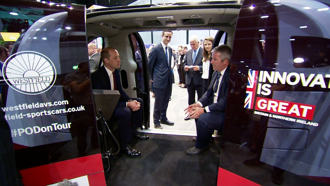 Prince William shakes a robotic hand at business festival