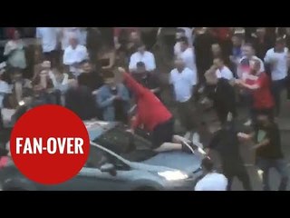 Football fan climbs on board MOVING car to celebrate England's world cup win