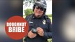 Hilarious footage shows a policeman being bribed with a doughnut.