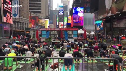 Yoga enthusiasts pack Times Square to celebrate summer solstice