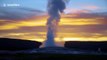 Yellowstone's Old Faithful geyser eruption captured at sunset