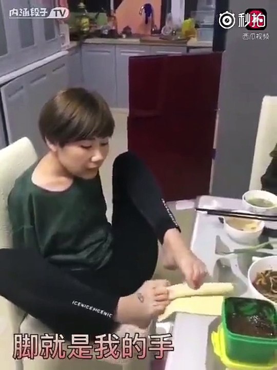 Hitched lady without hands working with the assistance of legs