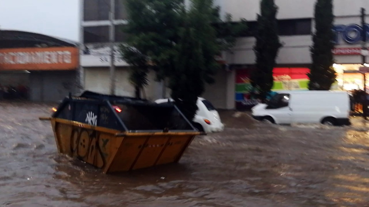 Dumpster Floats Down Flooded Street