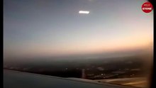 A passenger filming a flying saucer UFO in the plasma state from airplane