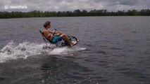 Man drinks beer while sitting on a lawn chair attached to a jetsurf board